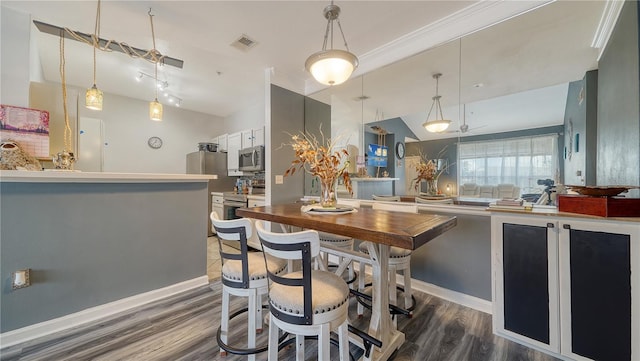 dining space featuring lofted ceiling and dark hardwood / wood-style flooring