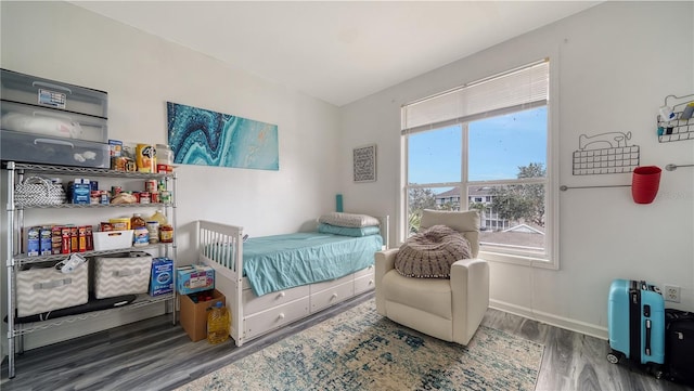 bedroom with dark hardwood / wood-style flooring