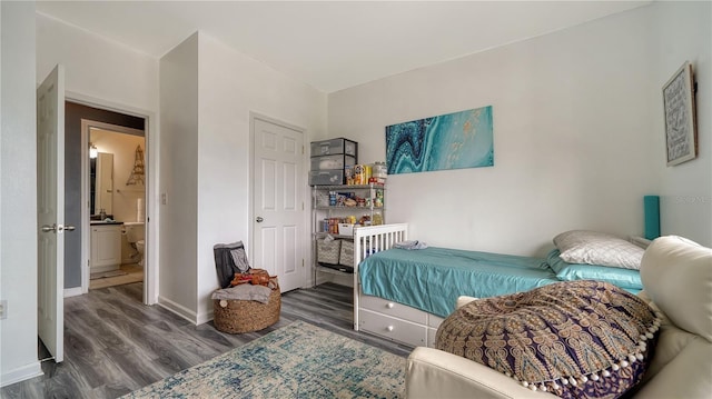 bedroom with dark hardwood / wood-style floors