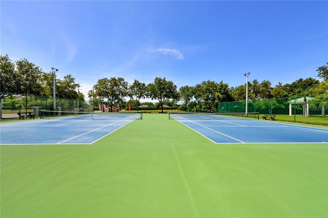 view of sport court featuring a playground