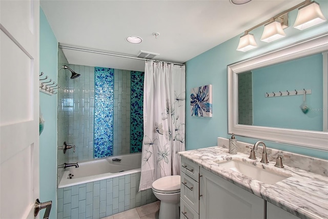 full bathroom with vanity, tile patterned floors, toilet, and shower / bath combo with shower curtain