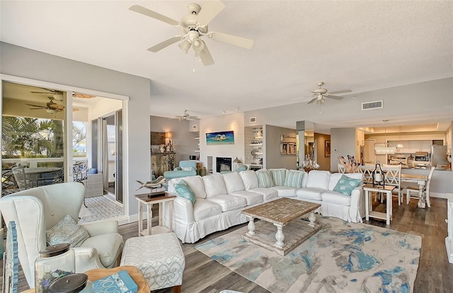 living room featuring ceiling fan and dark hardwood / wood-style floors