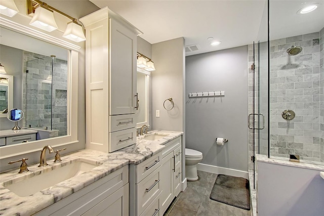 bathroom with vanity, tile patterned flooring, a shower with door, and toilet