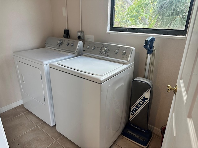 laundry room with light tile patterned floors and independent washer and dryer