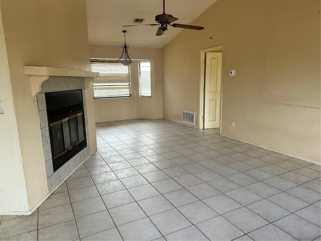 unfurnished living room featuring ceiling fan, light tile patterned floors, a tile fireplace, and lofted ceiling