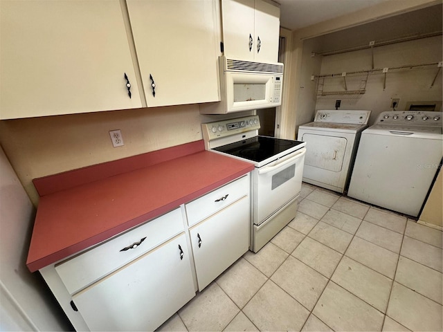 kitchen with light tile patterned floors, independent washer and dryer, white appliances, and white cabinets