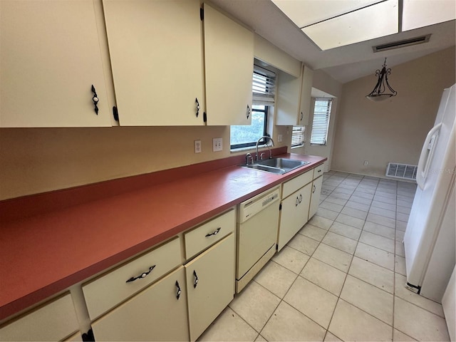 kitchen featuring pendant lighting, white appliances, lofted ceiling, sink, and light tile patterned flooring