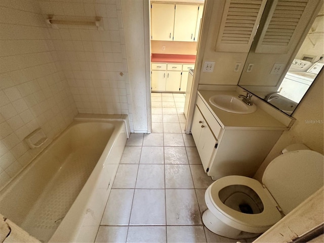 bathroom featuring tile patterned floors, a bath, toilet, and vanity