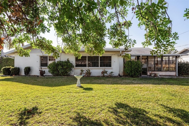 807 62nd St W, Bradenton, FL 34209 - ranch-style home with a front yard, a sunroom, and stucco siding
