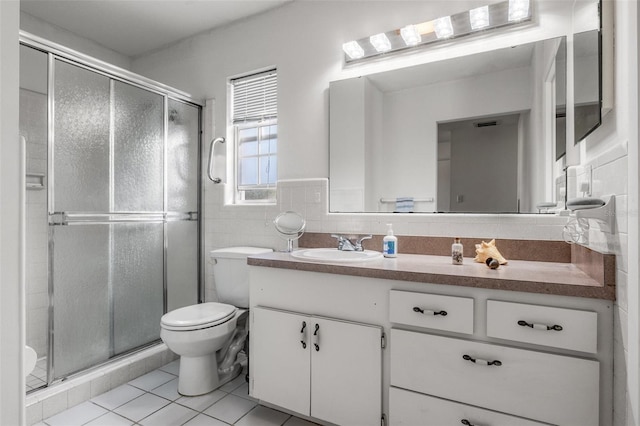 807 62nd St W, Bradenton, FL 34209 - full bathroom featuring tile patterned floors, vanity, a stall shower, toilet, and tile walls