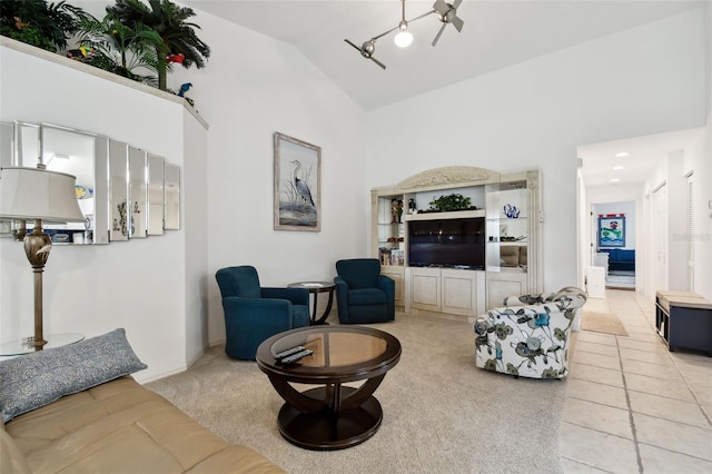 carpeted living room featuring high vaulted ceiling