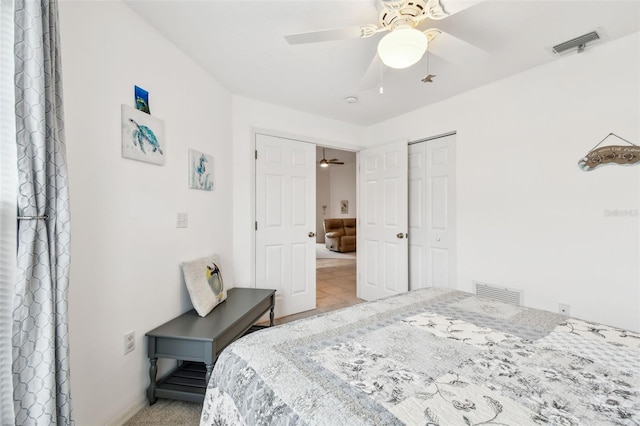 bedroom featuring light tile patterned flooring, a closet, and ceiling fan