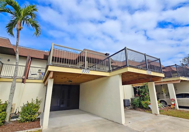 exterior space featuring a carport and central AC unit