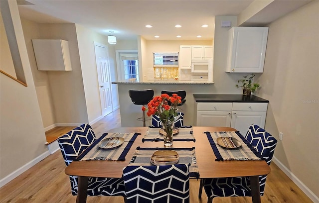 dining space featuring light hardwood / wood-style flooring