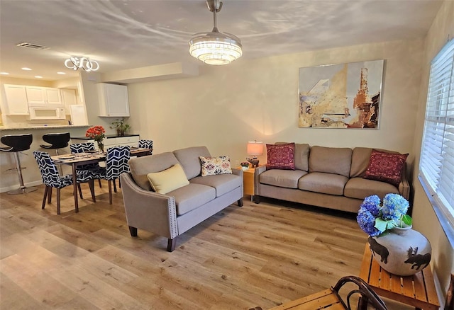 living room with plenty of natural light and light hardwood / wood-style floors