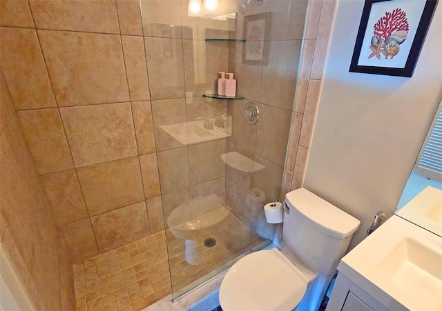 bathroom featuring vanity, toilet, and a tile shower