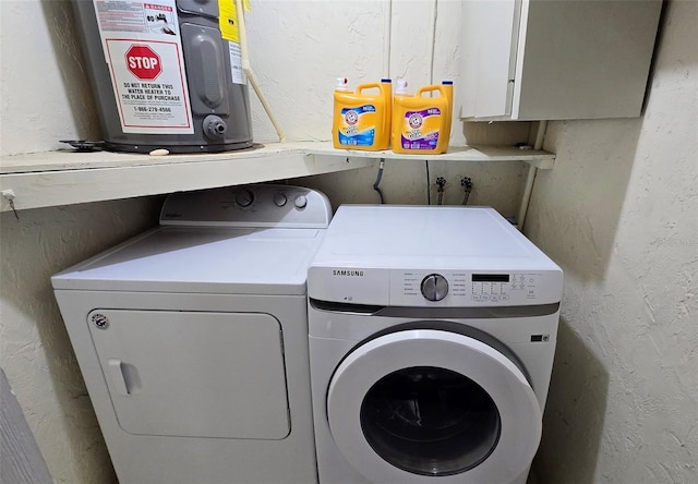 clothes washing area with washer and clothes dryer