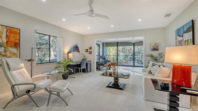 interior space featuring light colored carpet and ceiling fan