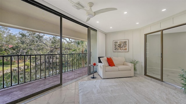 sunroom featuring ceiling fan