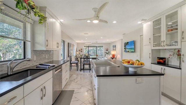 kitchen with dishwasher, sink, and white cabinets