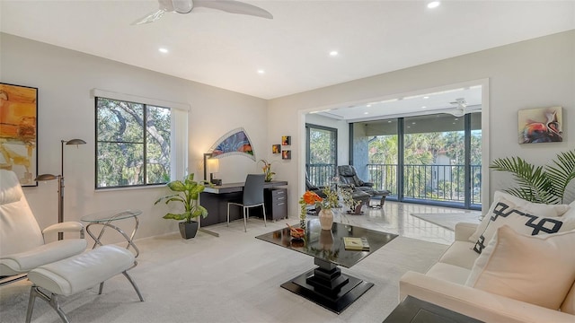 carpeted living room featuring ceiling fan