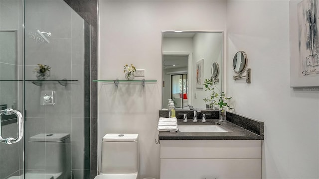 bathroom with vanity, toilet, and an enclosed shower