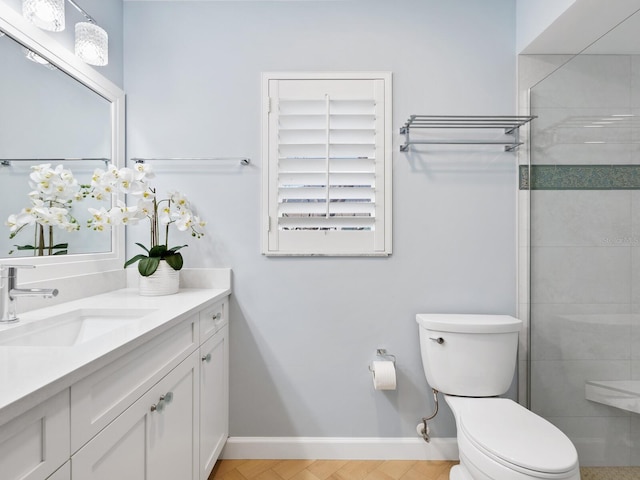 bathroom featuring vanity, toilet, and an enclosed shower