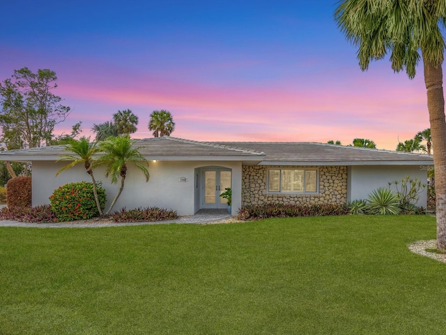 single story home featuring a yard and french doors