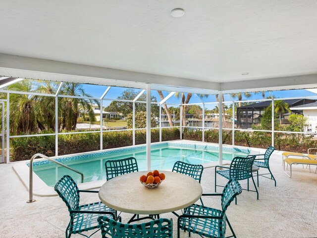 view of pool featuring a patio and glass enclosure