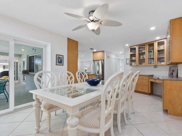 dining space featuring light tile patterned flooring and ceiling fan