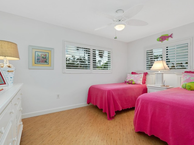 bedroom with light hardwood / wood-style floors and ceiling fan