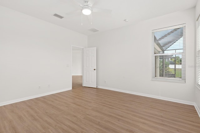 empty room featuring ceiling fan and hardwood / wood-style flooring