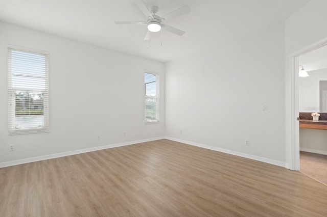 spare room featuring light hardwood / wood-style floors, plenty of natural light, and ceiling fan