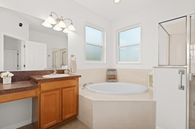 bathroom featuring vanity, independent shower and bath, and an inviting chandelier