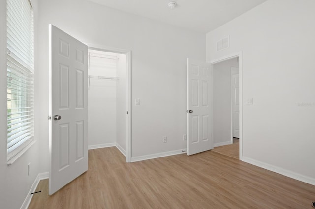 unfurnished bedroom featuring light wood-type flooring and a closet