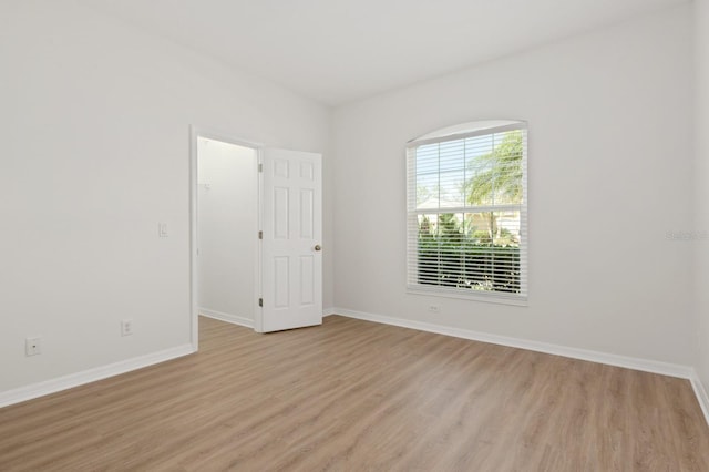 empty room with light hardwood / wood-style flooring