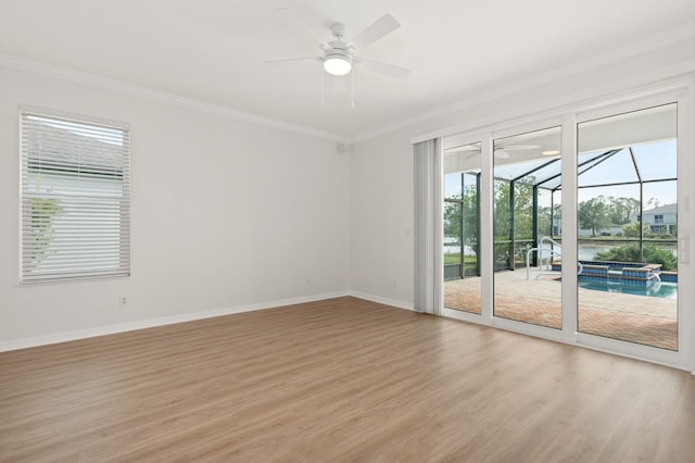 spare room featuring ceiling fan, crown molding, and light hardwood / wood-style flooring