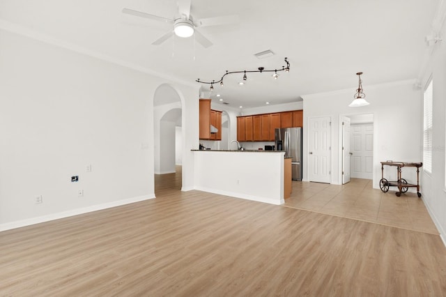 unfurnished living room featuring ceiling fan, crown molding, light hardwood / wood-style floors, and sink