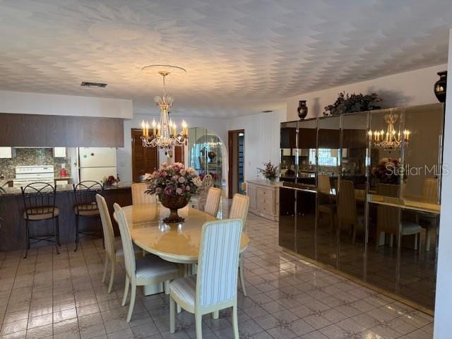 dining space featuring an inviting chandelier