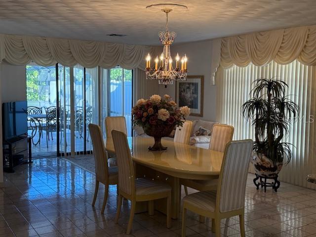 dining room featuring a notable chandelier and a textured ceiling