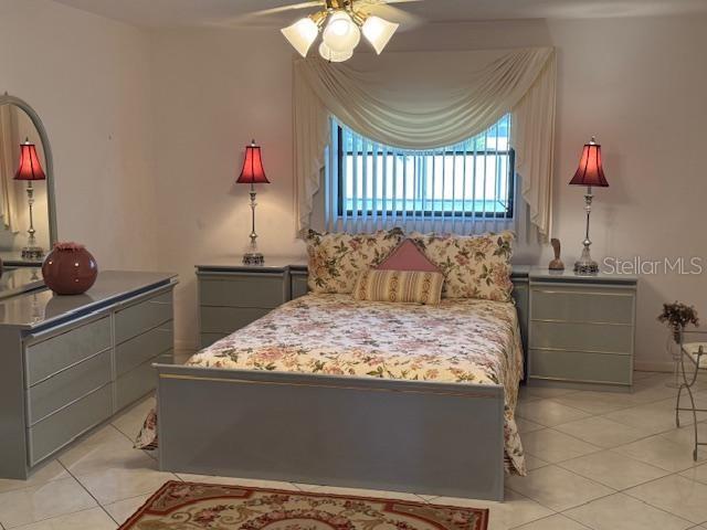 bedroom featuring ceiling fan and light tile patterned flooring