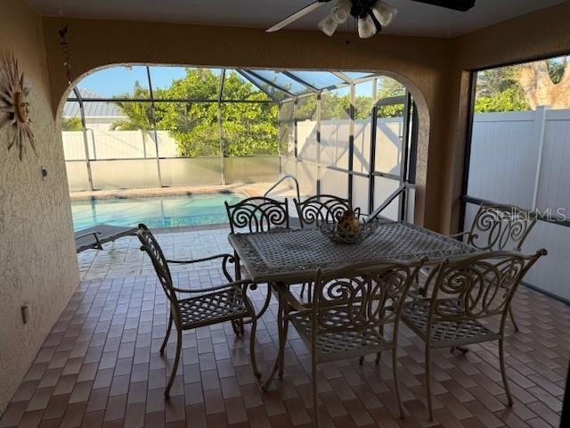 view of patio / terrace with ceiling fan and glass enclosure