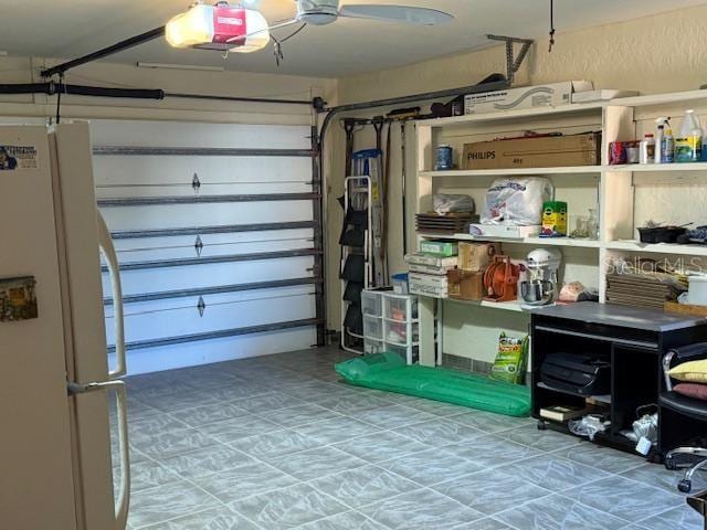 garage featuring a garage door opener and white refrigerator