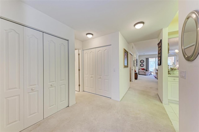 corridor featuring light colored carpet