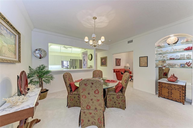 carpeted dining area with crown molding and a chandelier