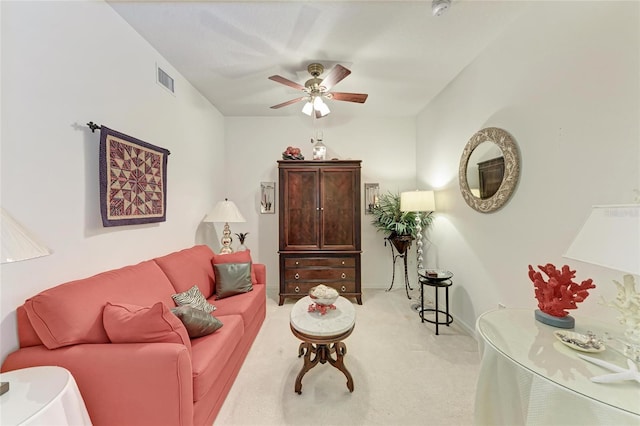 carpeted living room with ceiling fan