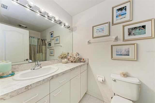 bathroom featuring tile patterned floors, toilet, and vanity