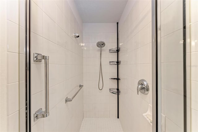 bathroom with tiled shower