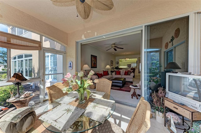 dining space with ceiling fan and a textured ceiling