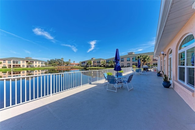 view of pool with a water view and a patio area